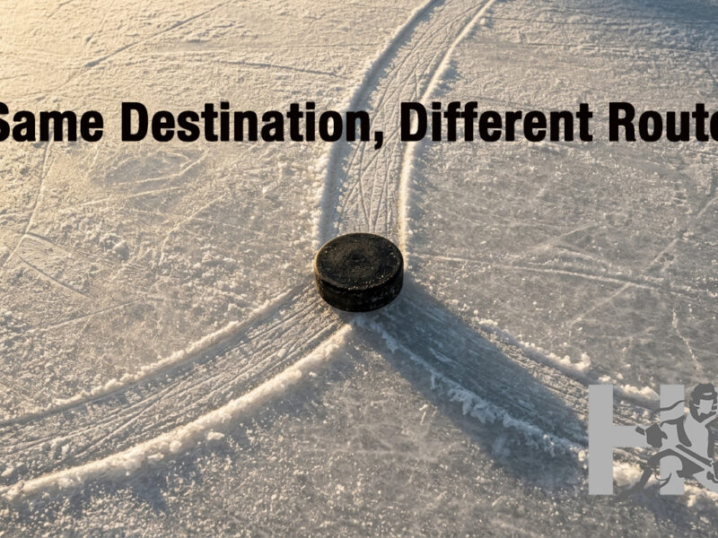 A puck at the point where one skate trail splits into two, representing the AAA to prep school or junior hockey decision point
